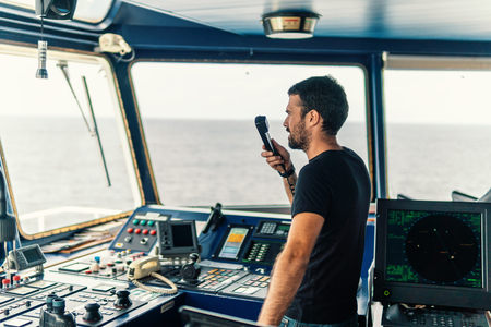 Marine navigational officer is reporting by VHF radioの写真素材