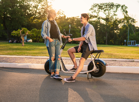 Lovely young happy couple with electric bikeの写真素材
