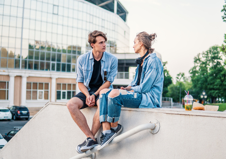 Lovely young hipster couple dating during summer sunset.の写真素材