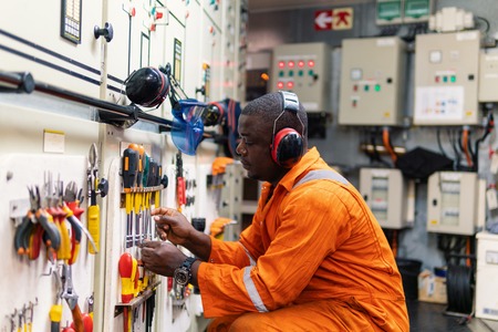 Marine engineer officer working in engine roomの写真素材