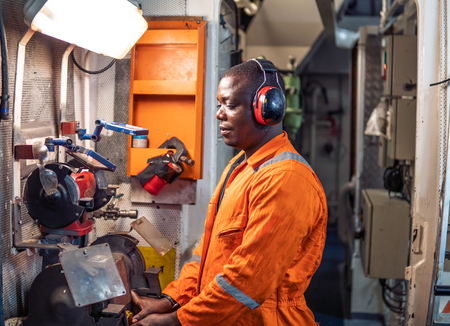 Marine engineer officer working in engine roomの写真素材