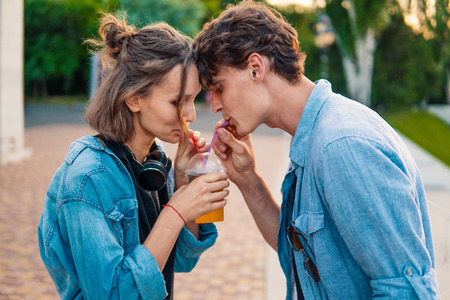 Lovely young hipster couple dating during summer sunset.の写真素材