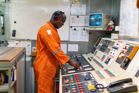 Marine engineer officer working in engine roomの写真素材