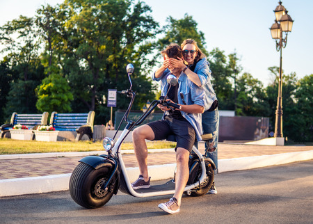 Lovely young couple dating with electric bike.の写真素材
