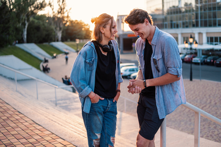 Lovely young hipster couple dating during summer sunset.の写真素材