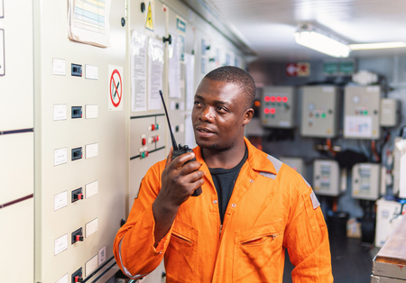 Marine engineer officer working in engine roomの写真素材