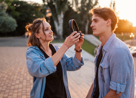 Lovely young hipster couple dating during summer sunset.の写真素材