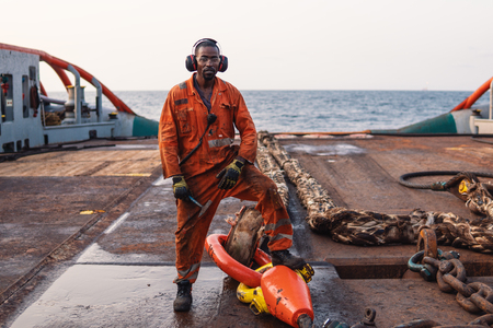 Seaman AB or Bosun on deck of offshore vessel or shipの写真素材