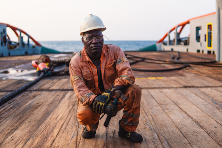 Seaman AB or Bosun on deck of offshore vessel or shipの写真素材