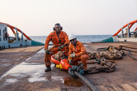 Seaman AB or Bosun on deck of offshore vessel or shipの写真素材