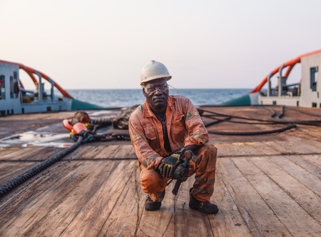 Seaman AB or Bosun on deck of offshore vessel or shipの写真素材