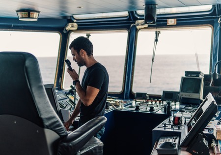 Marine navigational officer is reporting by VHF radioの写真素材