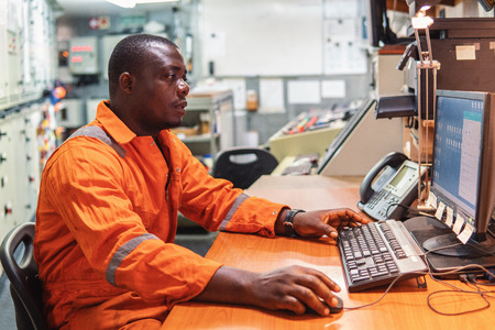Marine engineer officer working in engine roomの写真素材