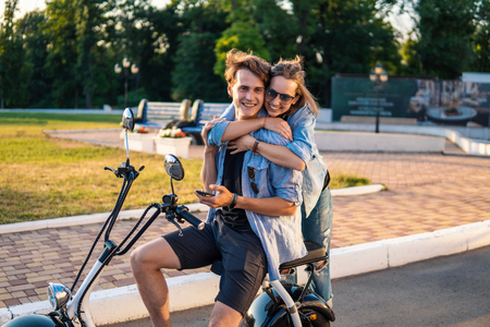 Lovely young couple dating with electric bike.の写真素材