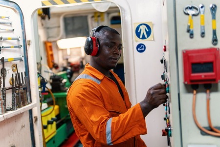 Marine engineer officer working in engine roomの写真素材