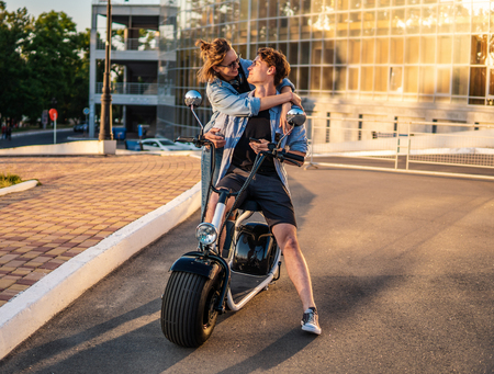 Lovely young couple dating with electric bike.の写真素材
