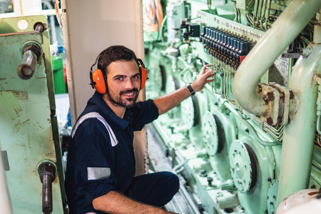 Marine engineer officer working in engine roomの写真素材