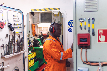 Marine engineer officer working in engine roomの写真素材