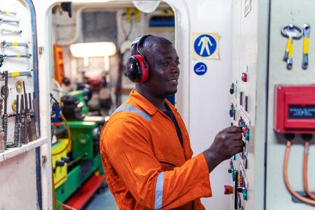 Marine engineer officer working in engine roomの写真素材