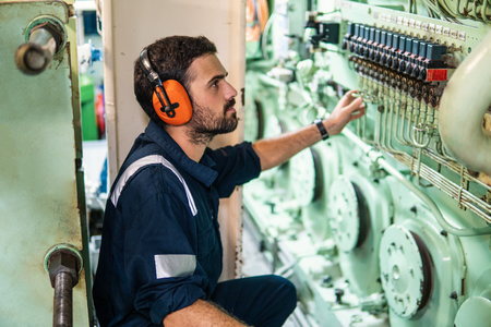 Marine engineer officer working in engine roomの写真素材