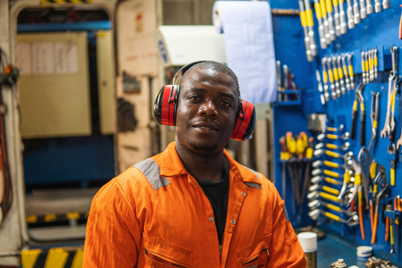 Marine engineer officer working in engine roomの写真素材