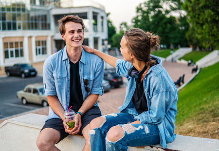 Lovely young hipster couple dating during summer sunset.の写真素材