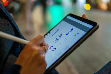 woman drawing on digital tablet with stylus pencil.の写真素材