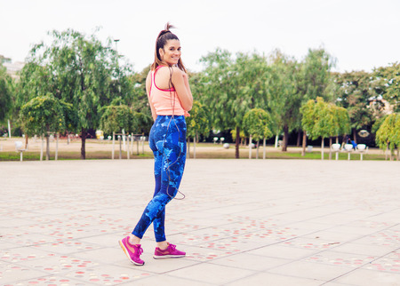 Fit beautiful woman with jumping rope in a parkの写真素材