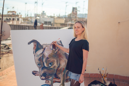Young woman paint artist drawing at home roofの写真素材