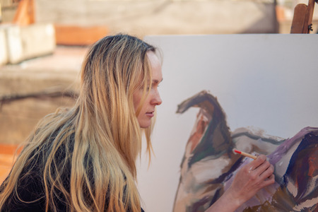 Young woman paint artist drawing at home roof
