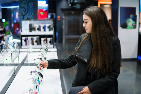 woman testing smart watch in modern storeの写真素材