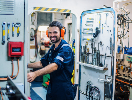Marine engineer officer working in engine roomの写真素材