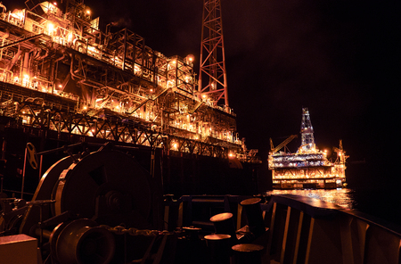 FPSO tanker vessel near Oil platform Rig at night. Offshore oil and gas industryの写真素材