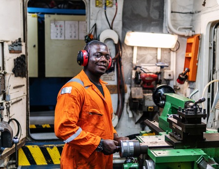 Marine engineer officer working in engine roomの写真素材