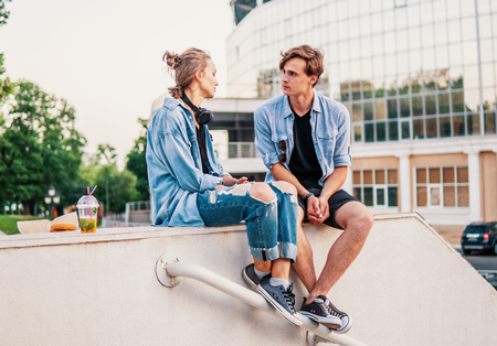 Lovely young hipster couple dating during summer sunset.の写真素材