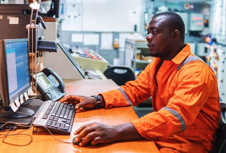 Marine engineer officer working in engine roomの写真素材