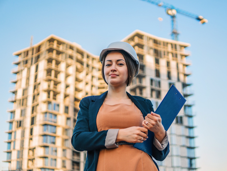beatiful business woman engineer is standing with plan papers.の写真素材