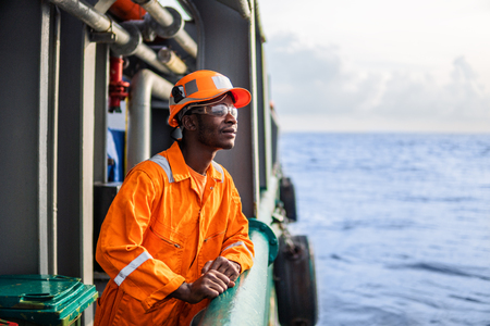 Tired Seaman AB or Bosun on deck of vessel or shipの写真素材