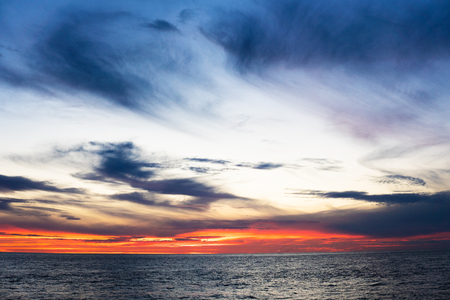 Amazing sunset, sea, the sun with clouds and sun reflection.の写真素材