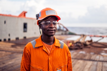 Tired Seaman AB or Bosun on deck of vessel or shipの写真素材