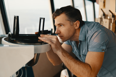 deck officer taking magnetic compass error onboard of vesselの写真素材