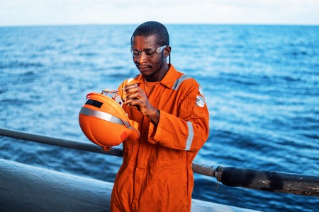 happy Seaman AB or Bosun on deck of vessel or shipの写真素材