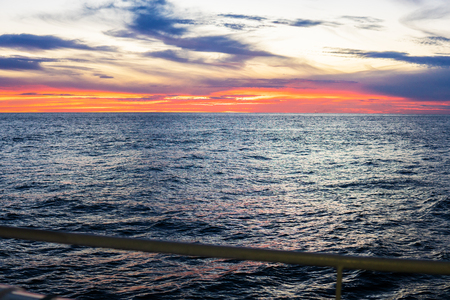 Amazing sunset, sea, the sun with clouds and sun reflection.の写真素材