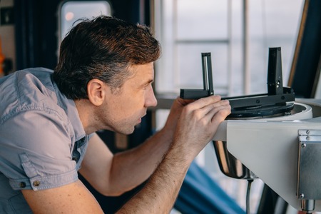 deck officer taking magnetic compass error onboard of vesselの写真素材