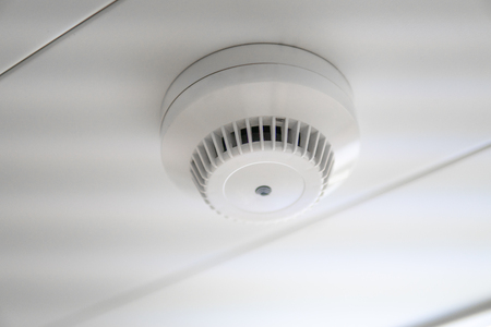 smoke detector and fire sensor on a ceilingの写真素材