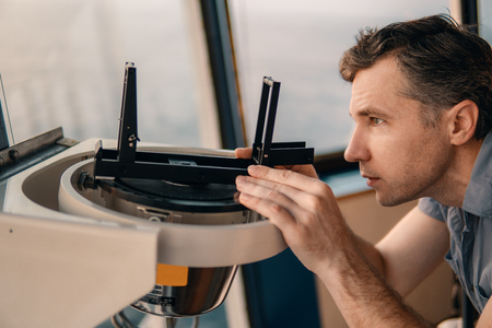 deck officer taking magnetic compass error onboard of vesselの写真素材