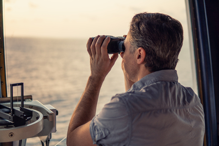 Navigational officer lookout on navigation watch at seaの写真素材