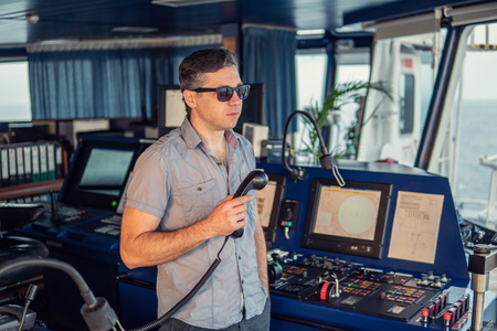 Marine navigational officer is reporting by VHF radioの写真素材