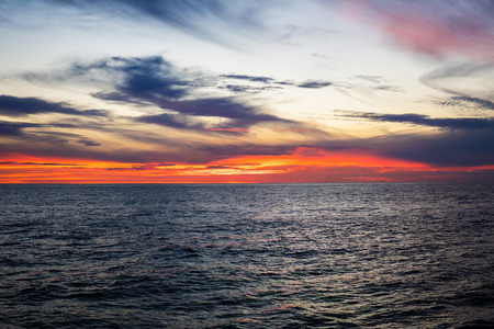 Amazing sunset, sea, the sun with clouds and sun reflection.の写真素材