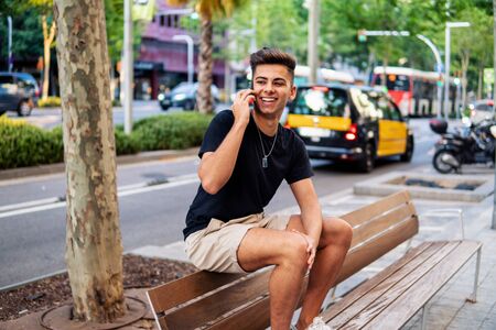 man on the street talking on a cell phoneの写真素材